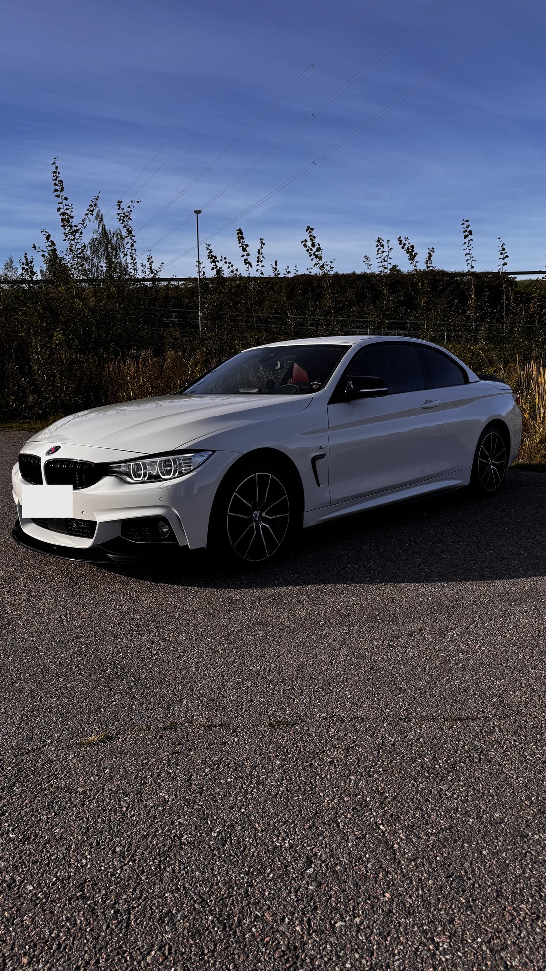 Valge BMW 428i cabrio esinurga vaade õhtuvalguses pärast tööd